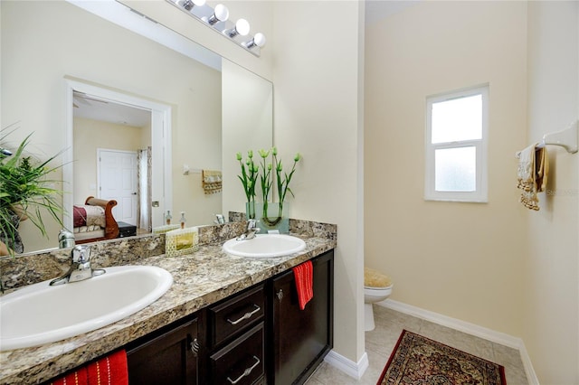 bathroom featuring tile patterned floors, vanity, and toilet