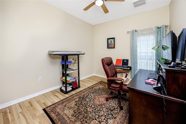 office with hardwood / wood-style flooring and ceiling fan