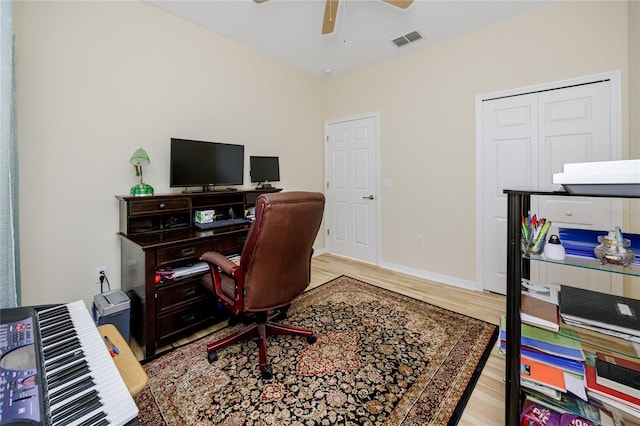 office space with ceiling fan and light hardwood / wood-style flooring