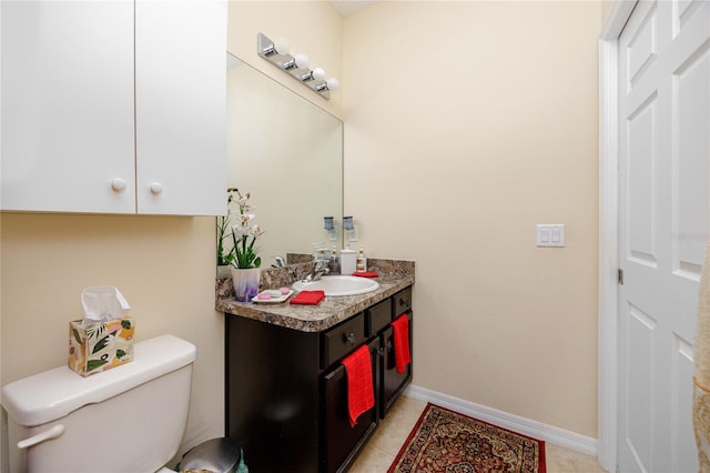 bathroom featuring tile patterned floors, vanity, and toilet