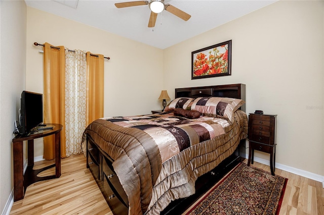 bedroom with light hardwood / wood-style flooring and ceiling fan