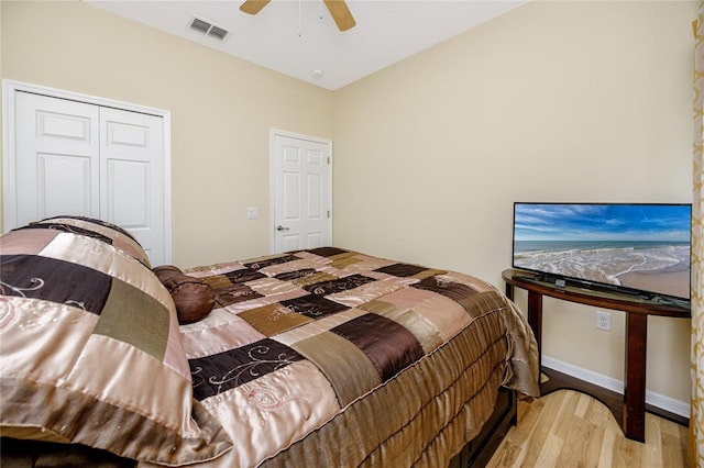 bedroom featuring ceiling fan, light hardwood / wood-style floors, and a closet