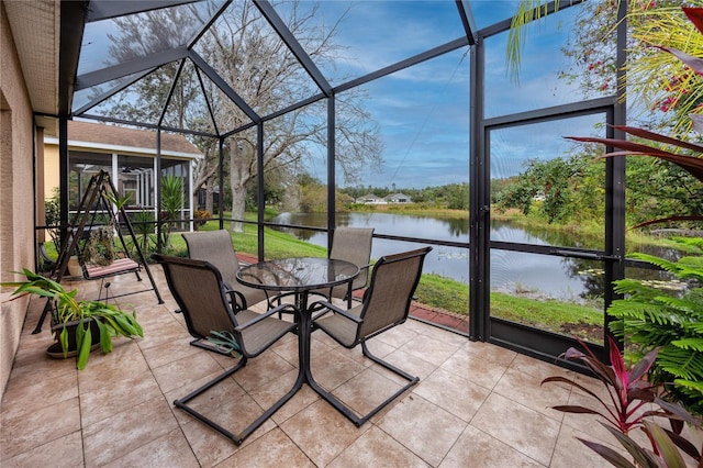 unfurnished sunroom featuring plenty of natural light and a water view