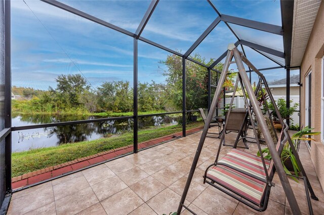 unfurnished sunroom with a water view and plenty of natural light