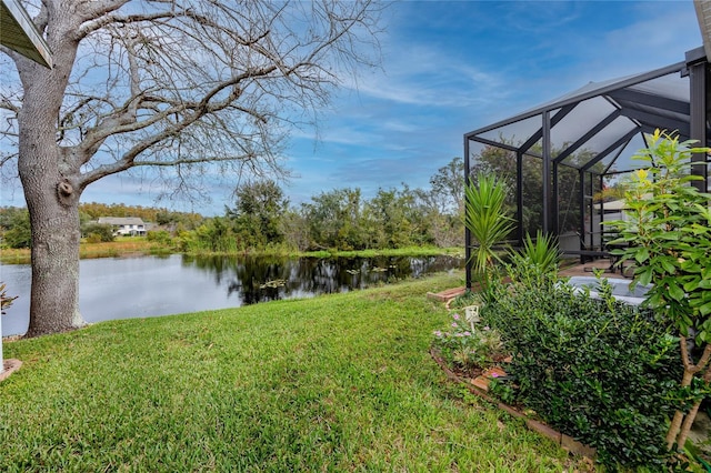 view of yard featuring a water view and glass enclosure