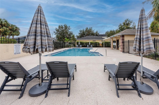 view of swimming pool with a patio