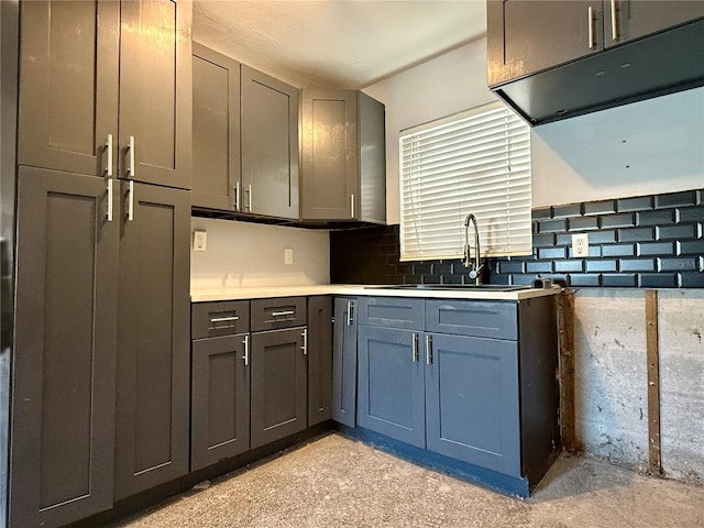 kitchen with tasteful backsplash, gray cabinetry, and sink