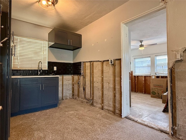 kitchen featuring ceiling fan, sink, and a textured ceiling