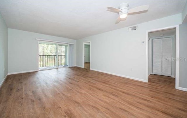 spare room with wood-type flooring and ceiling fan