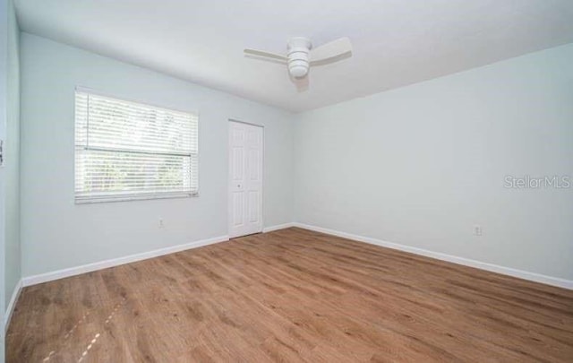 unfurnished room with hardwood / wood-style flooring and ceiling fan