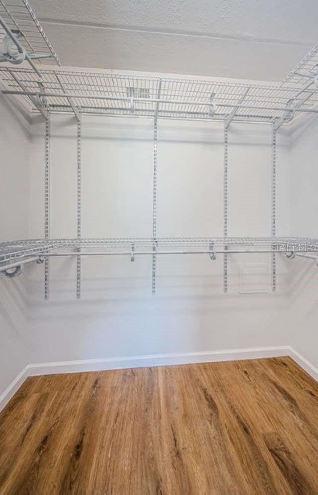 walk in closet featuring hardwood / wood-style flooring