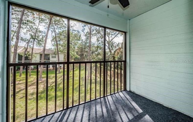 unfurnished sunroom with ceiling fan