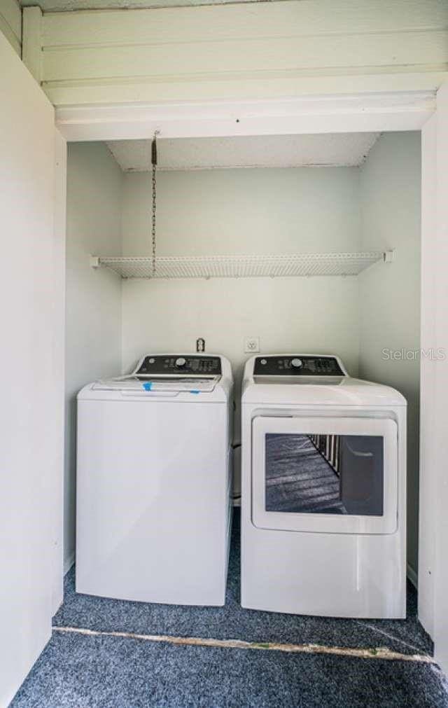 laundry area with washing machine and clothes dryer