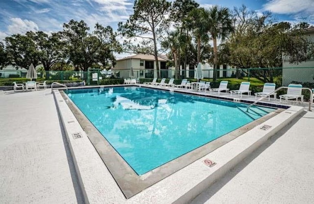 view of swimming pool featuring a patio area