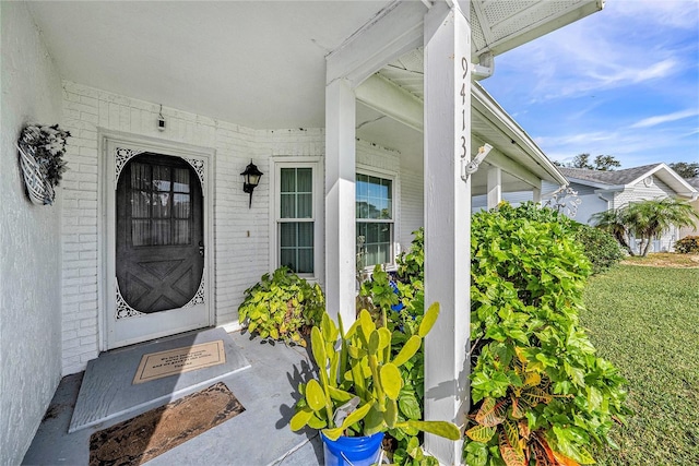 view of exterior entry featuring a yard