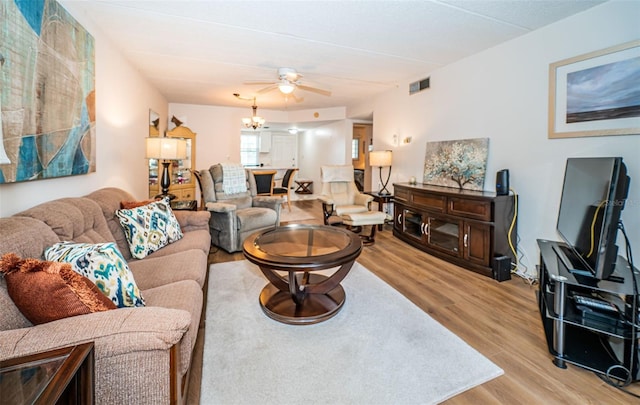 living room featuring ceiling fan and light hardwood / wood-style flooring