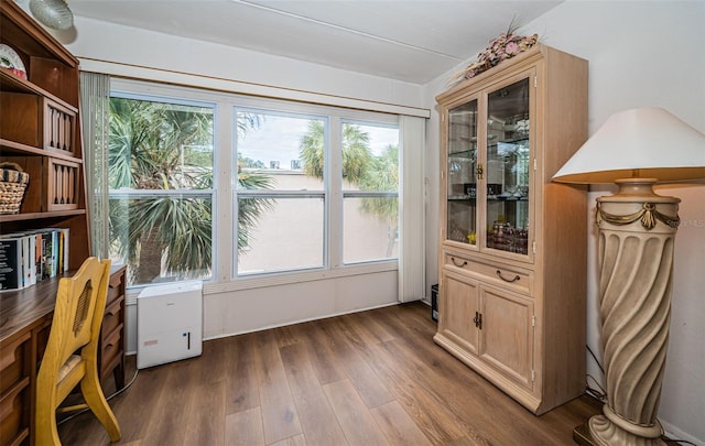 home office with dark hardwood / wood-style floors