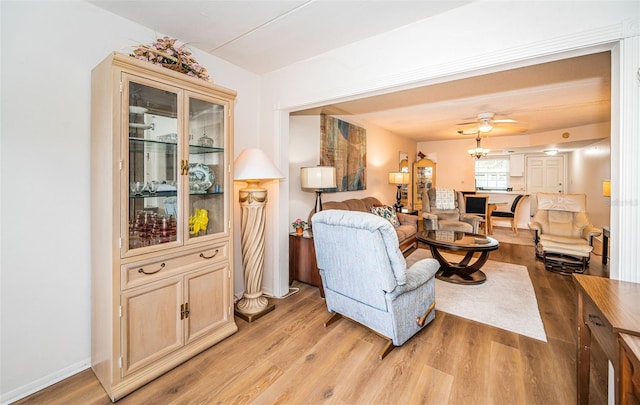 living room featuring ceiling fan and light wood-type flooring