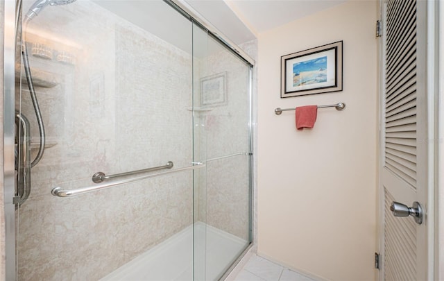 bathroom with tile patterned flooring and walk in shower