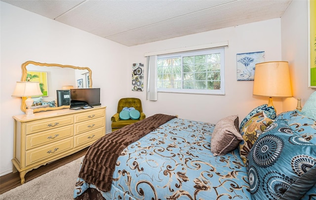 bedroom with hardwood / wood-style flooring