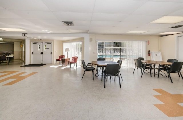 dining area with a paneled ceiling