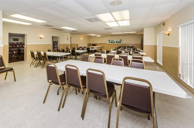 dining area featuring a drop ceiling