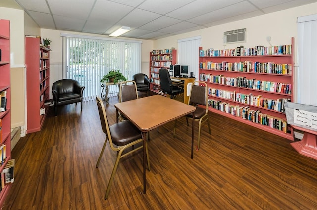 office with a drop ceiling and dark hardwood / wood-style floors