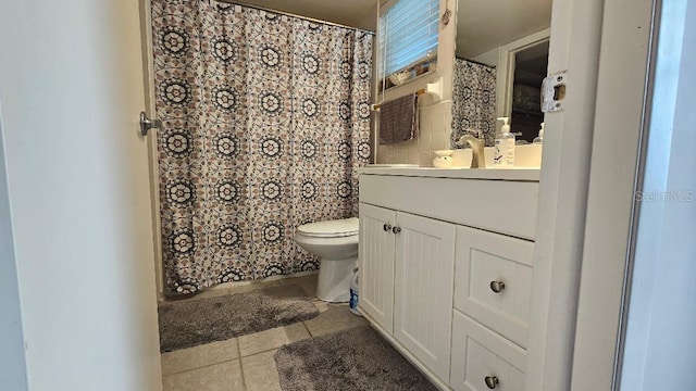 bathroom with tile patterned flooring, vanity, and toilet