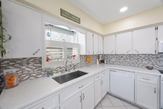 kitchen with white cabinets, sink, white appliances, and backsplash