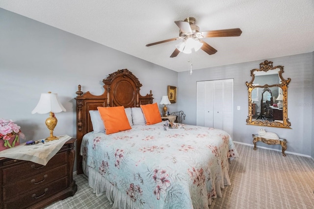 carpeted bedroom featuring a textured ceiling, ceiling fan, and a closet