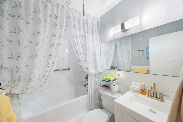 full bathroom with toilet, vanity, tile walls, and shower / tub combo