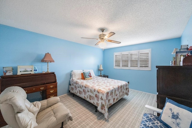 bedroom featuring a textured ceiling, carpet floors, and ceiling fan