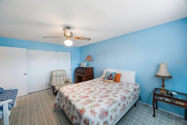 carpeted bedroom with a textured ceiling and ceiling fan