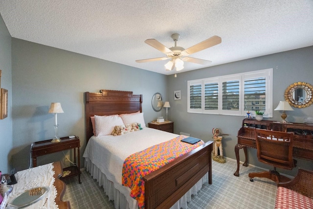 bedroom featuring ceiling fan and a textured ceiling