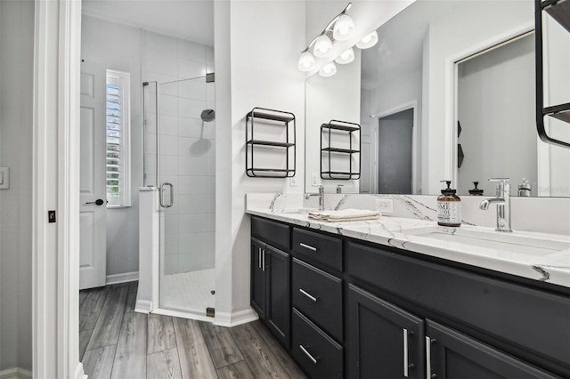 bathroom with vanity, wood-type flooring, and walk in shower