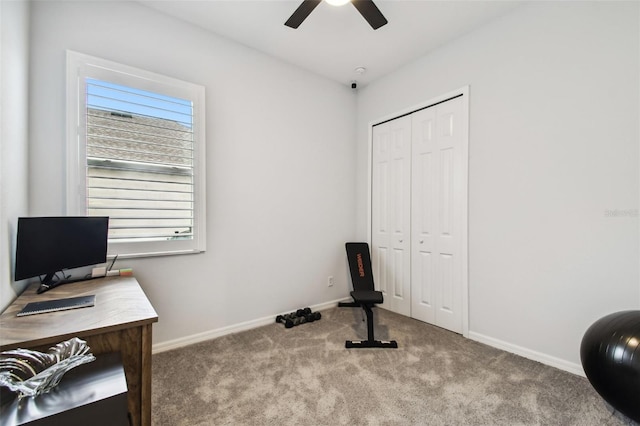 exercise room with carpet floors and ceiling fan