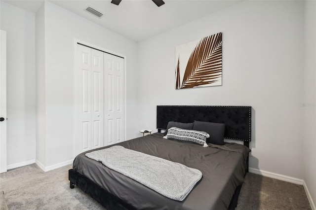 carpeted bedroom with ceiling fan and a closet