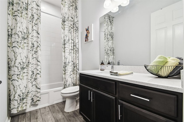 full bathroom featuring vanity, hardwood / wood-style flooring, toilet, and shower / bathtub combination with curtain