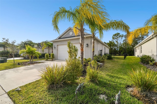 view of side of property featuring a lawn and a garage