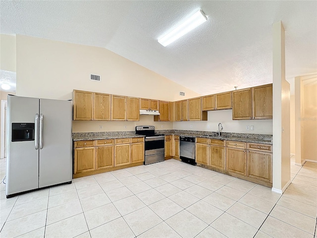 kitchen with stainless steel appliances, sink, a textured ceiling, light tile patterned floors, and high vaulted ceiling