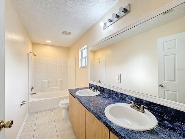 full bathroom with tile patterned flooring, tiled shower / bath, a textured ceiling, vanity, and toilet