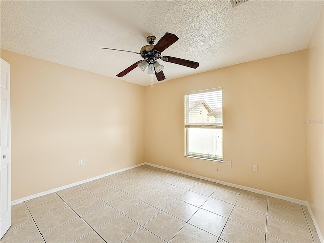 tiled spare room with a textured ceiling and ceiling fan