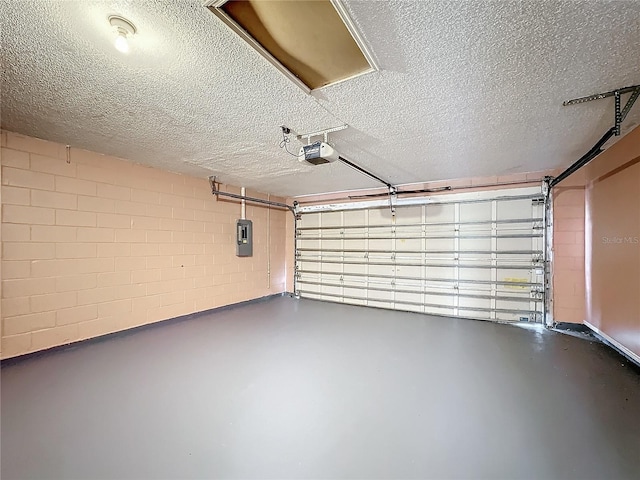 garage with a garage door opener and electric panel