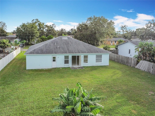 rear view of property with a yard