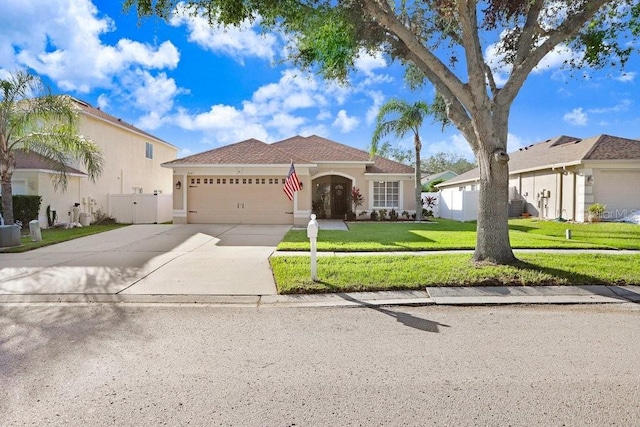 view of front of property featuring a garage and a front lawn