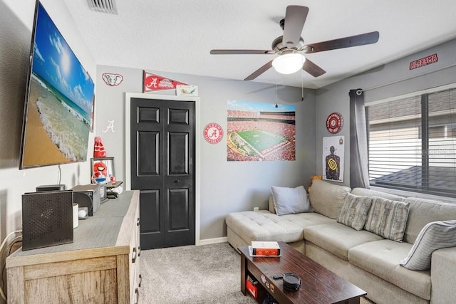 carpeted living room with ceiling fan