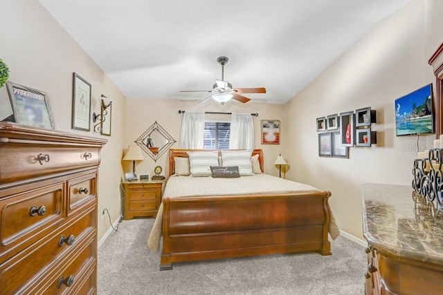 bedroom with vaulted ceiling, light carpet, and ceiling fan