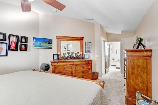 carpeted bedroom featuring a textured ceiling, lofted ceiling, and ceiling fan