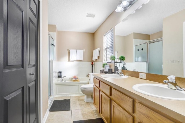 full bathroom featuring toilet, independent shower and bath, vanity, and tile patterned flooring