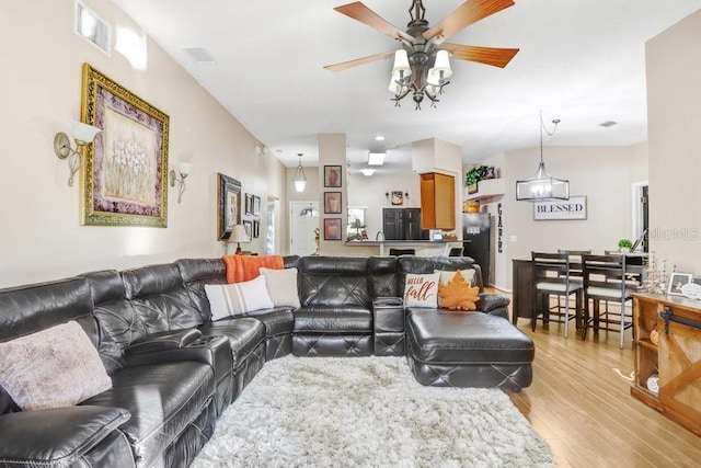 living room with ceiling fan and light hardwood / wood-style flooring